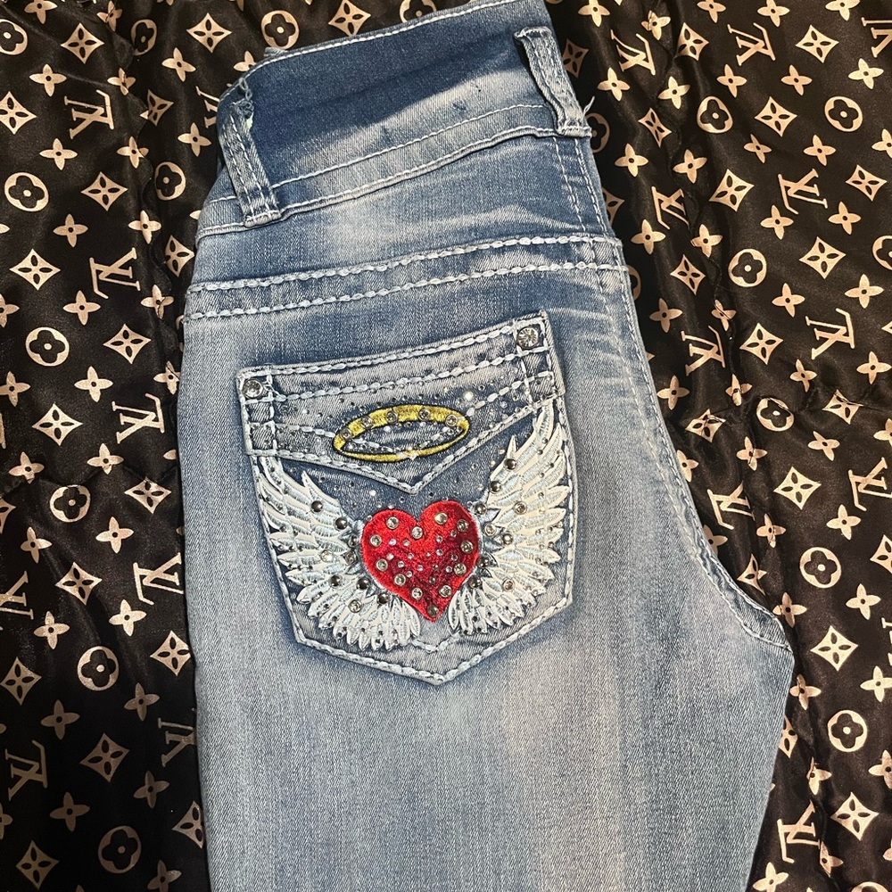 Y2K bootcut jeans with bedazzled heart & wings on back pockets.